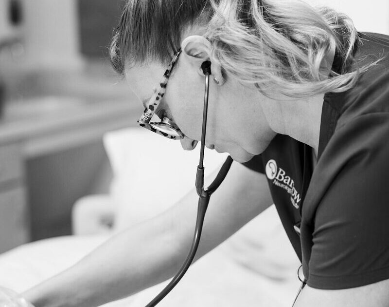 Barrow nurse treating a patient