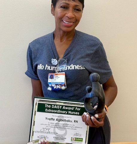 Barrow Nurse, Yvette Agbebaku, poses with her DAISY Award.