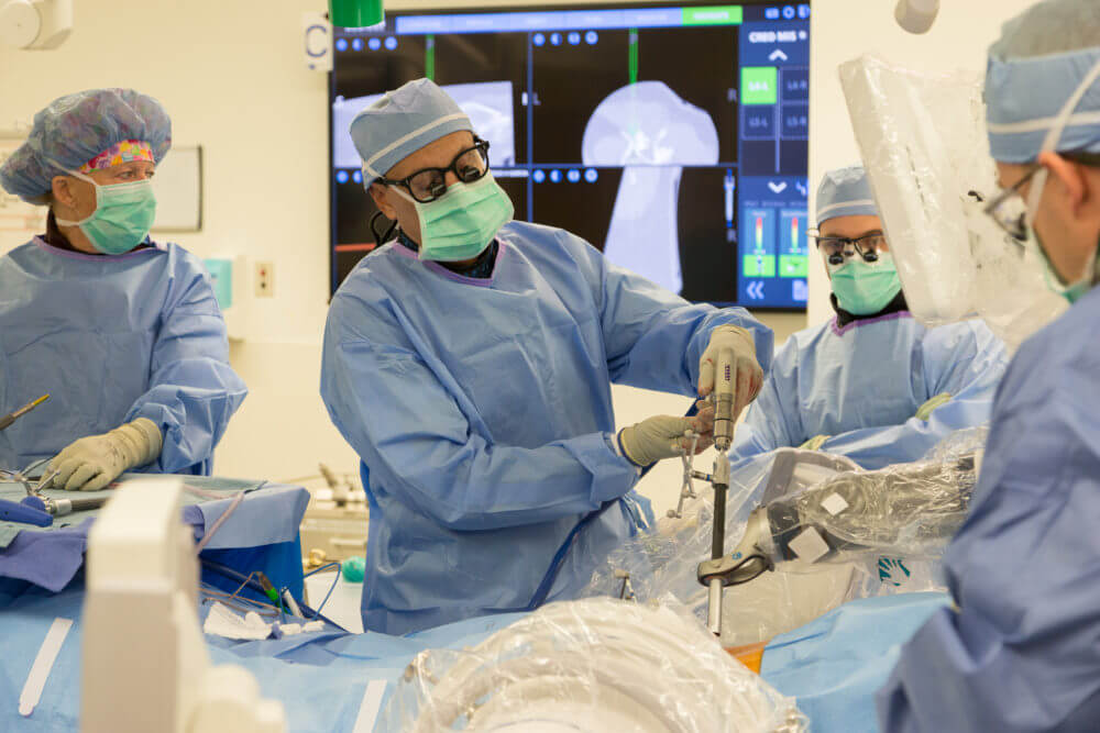 Dr. Juan Uribe using a surgical robot in the operating room