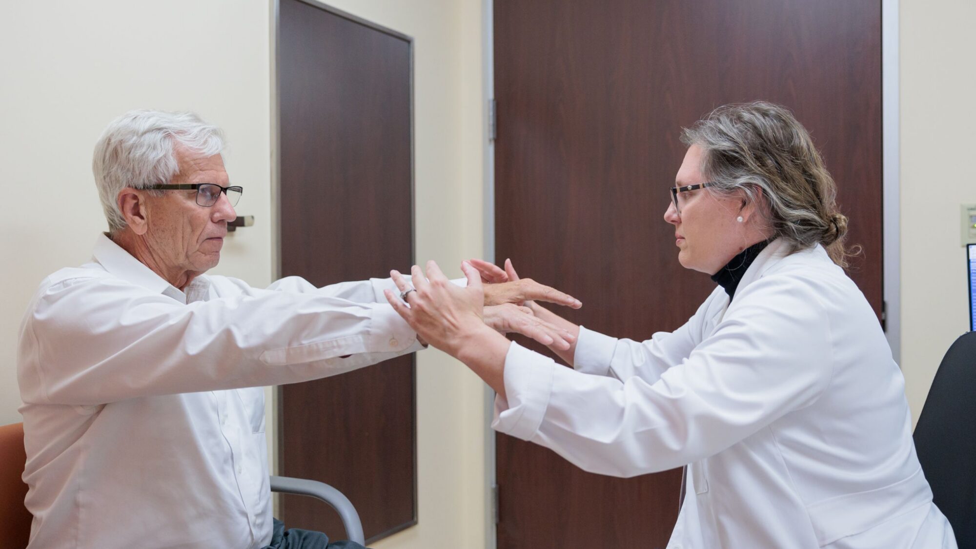 Movement disorders specialist Susan Criswell examines a patient.