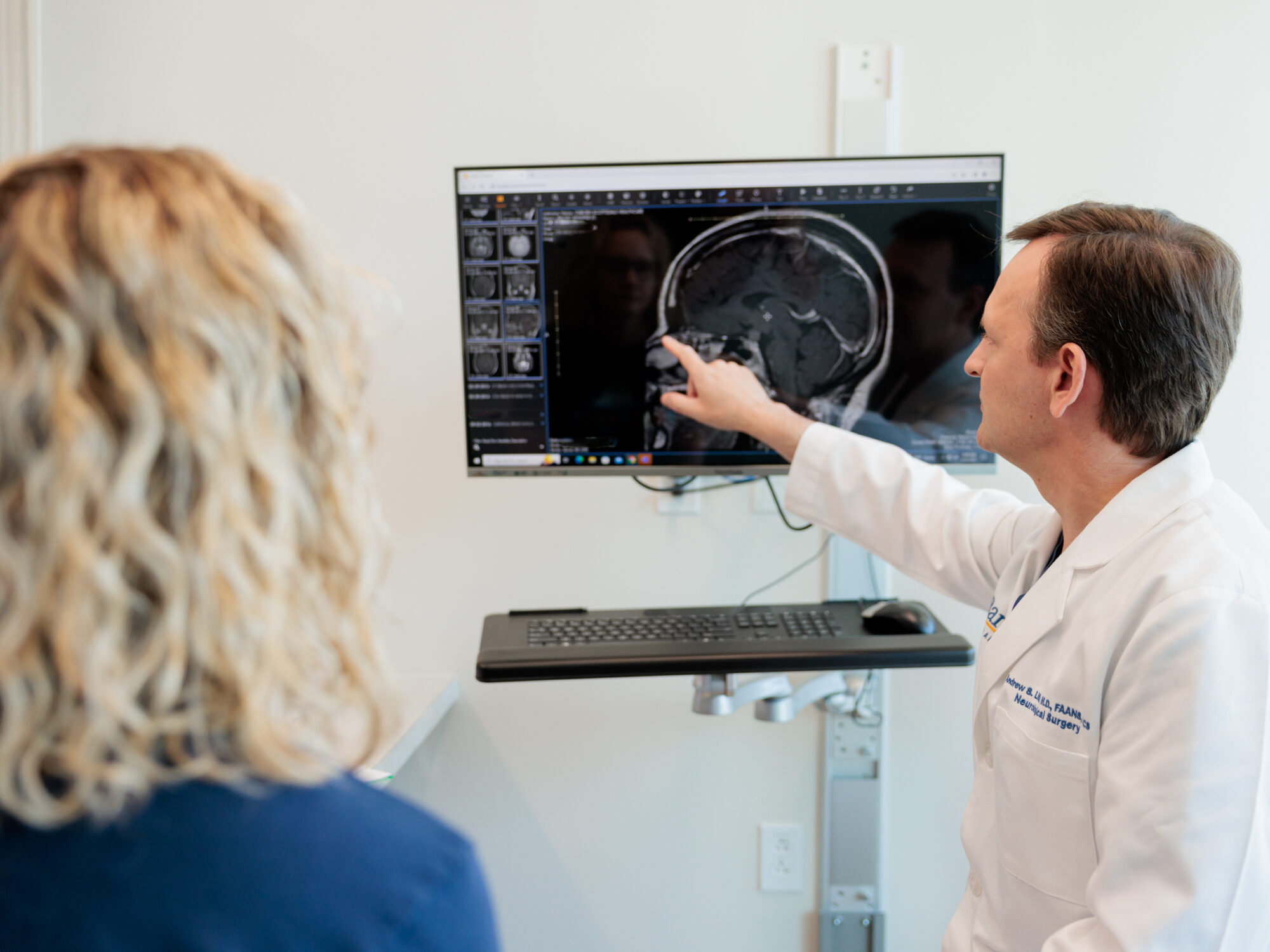 pituitary neurosurgeon andrew little discusses an mri scan with a patient