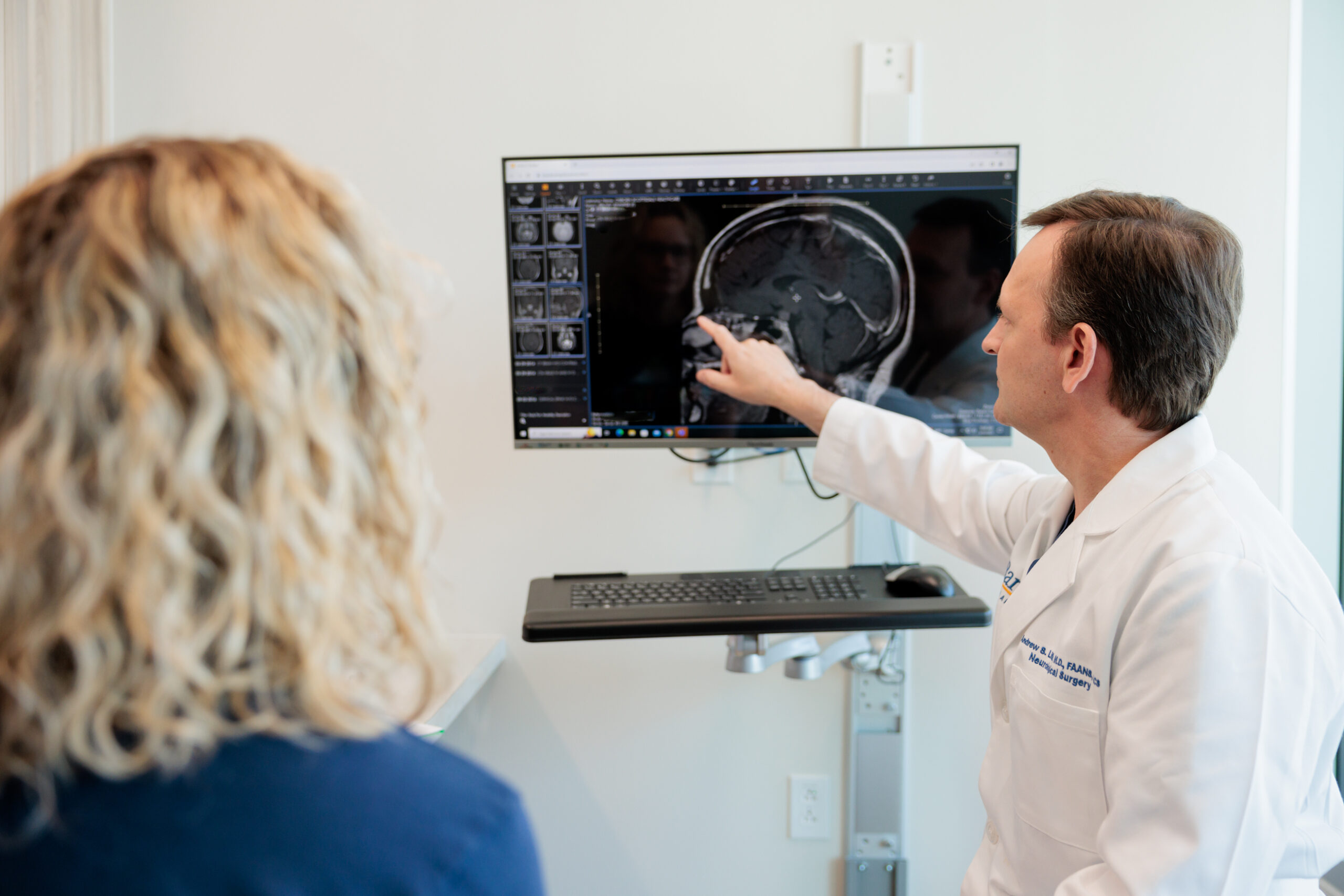 pituitary neurosurgeon andrew little discusses an mri scan with a patient