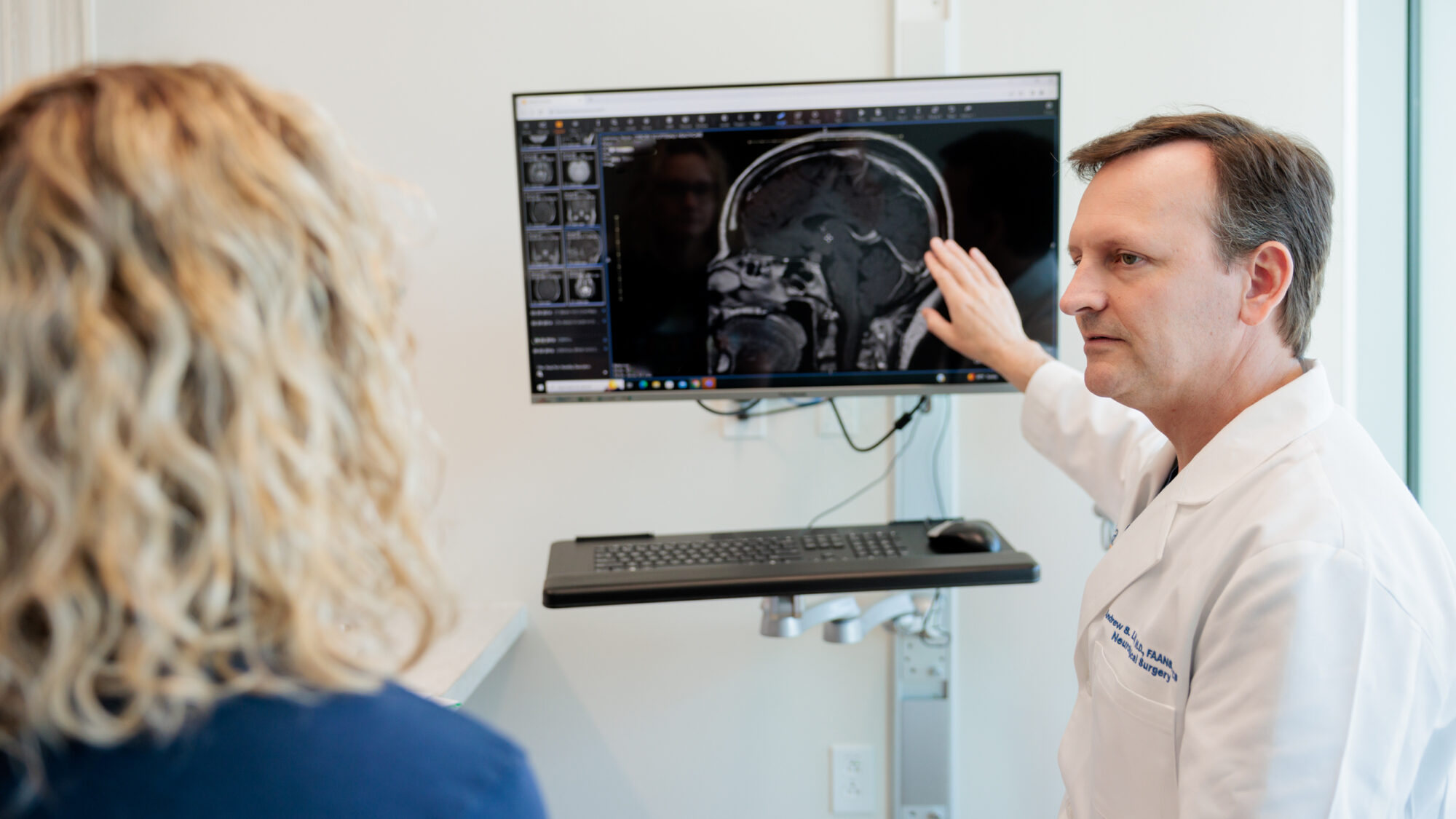 pituitary neurosurgeon andrew little discusses an mri scan with a patient