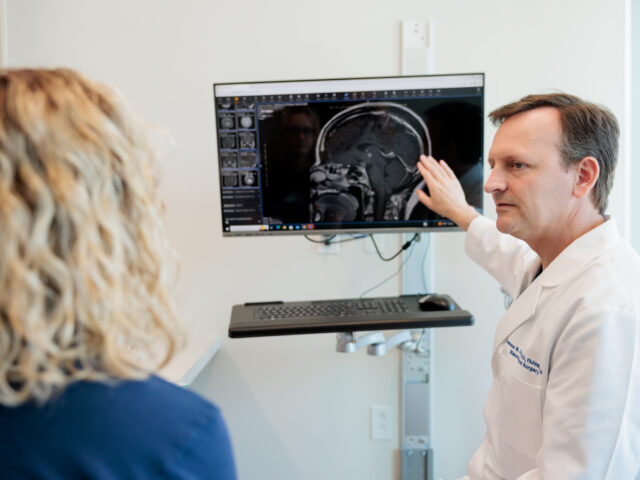 pituitary neurosurgeon andrew little discusses an mri scan with a patient