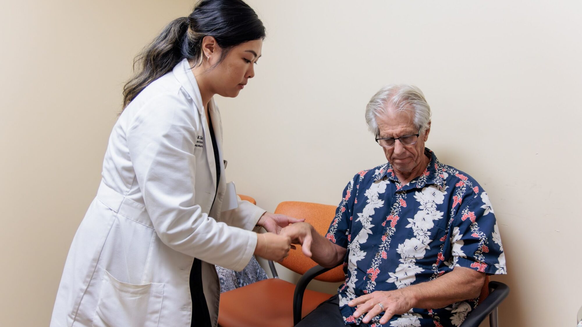 Justine Chan examines a movement disorders patient.