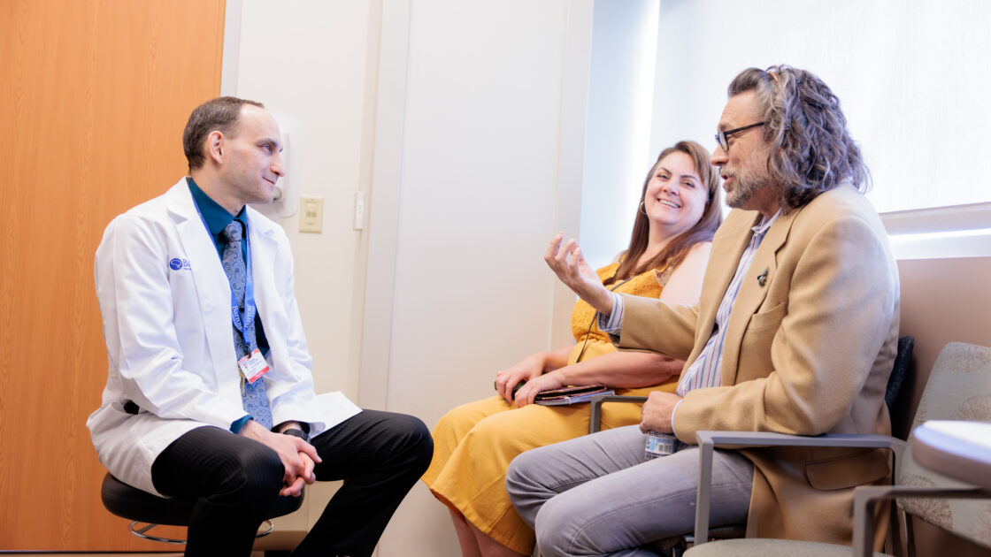 Dr. Vladimir Shvarts interacting with patient Randy Ehlers and the patient's friend in the clinic.
