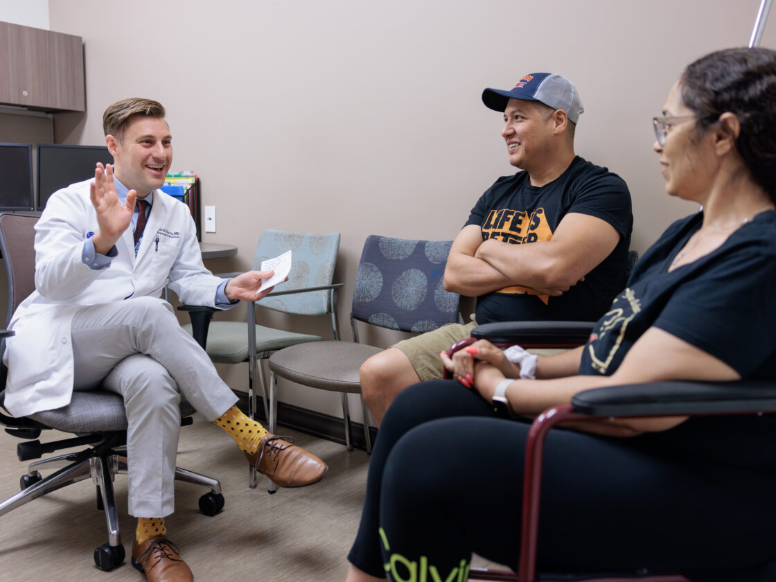 epilepsy specialist david harris talks with a patient and family in the barrow epilepsy center.