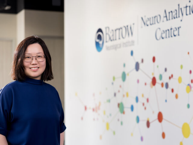 Portrait of Dr. Chia-Ling Phuah in front of the Barrow Neuro Analytics Center signage