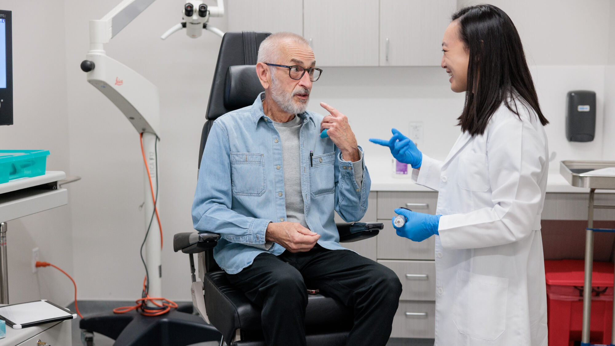 head and neck cancer surgeon deborah xie consults with a patient in an exam room