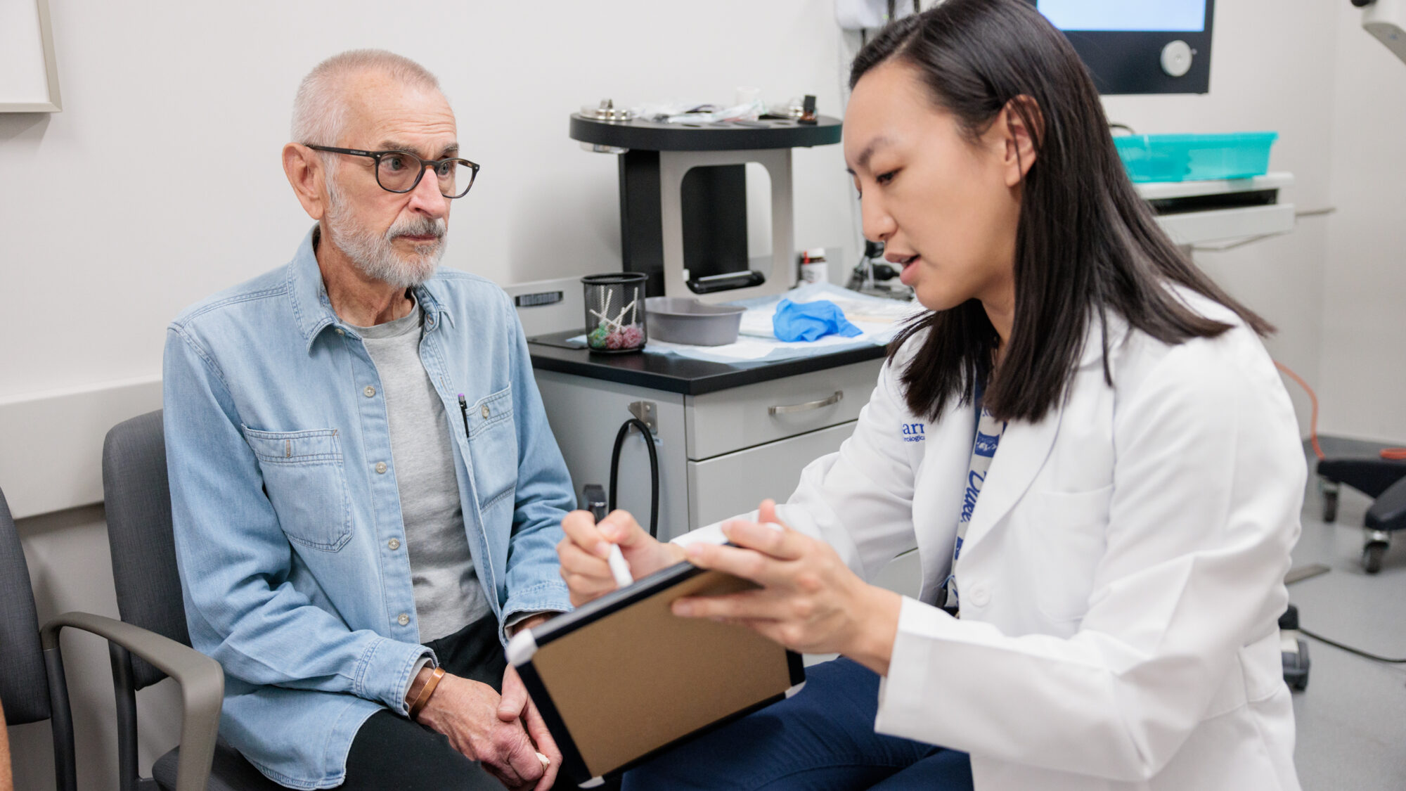 head and neck cancer surgeon deborah xie consults with a patient in an exam room