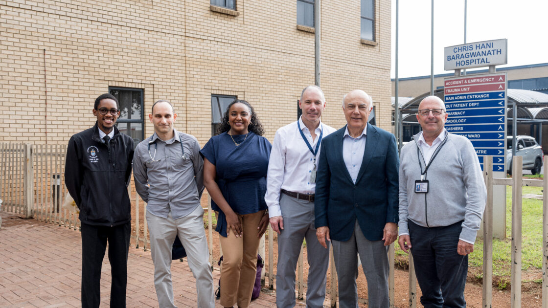 From L to R: Moyahabo Rampya, Dr. Shvarts, Dr. Mubarak, Dr. Racette, Markos Tambakeras and Dr. Andre Mochan stand outside Chris Hani Baragwanath Academic Hospital.