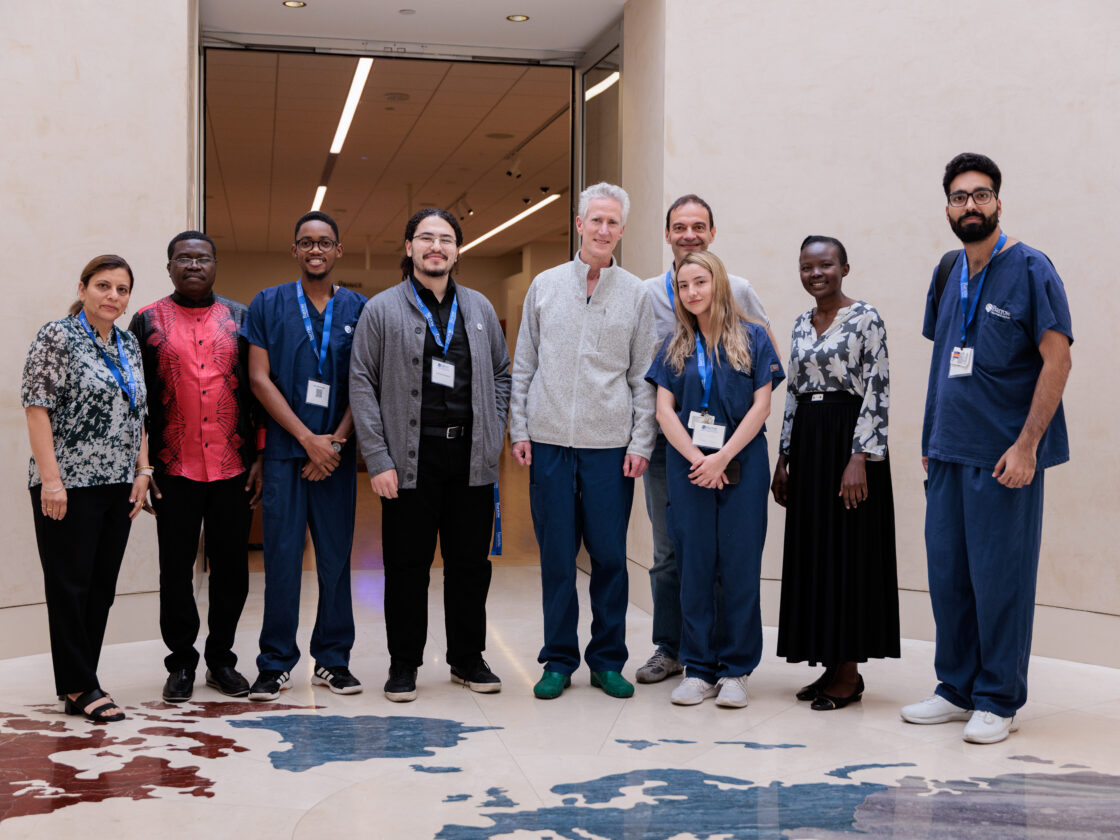 At the Musical Instrument Museum in Phoenix, Arizona, a group poses for a photo in a room where the floor is a map of the world.