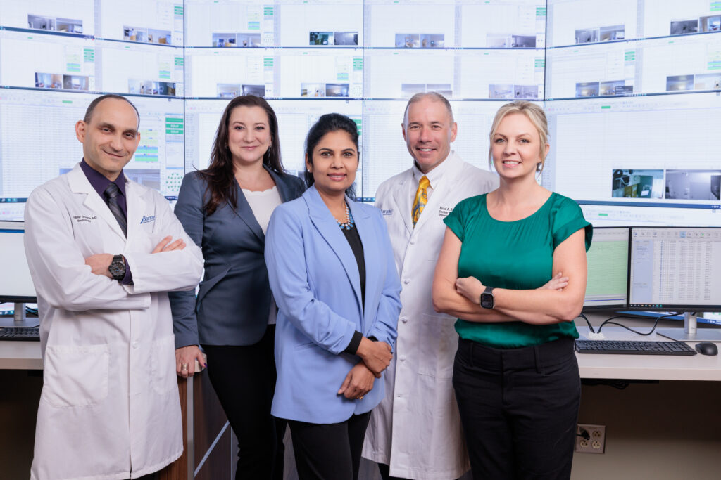 Group photo in front of the video wall of the Epilepsy Monitoring Unit