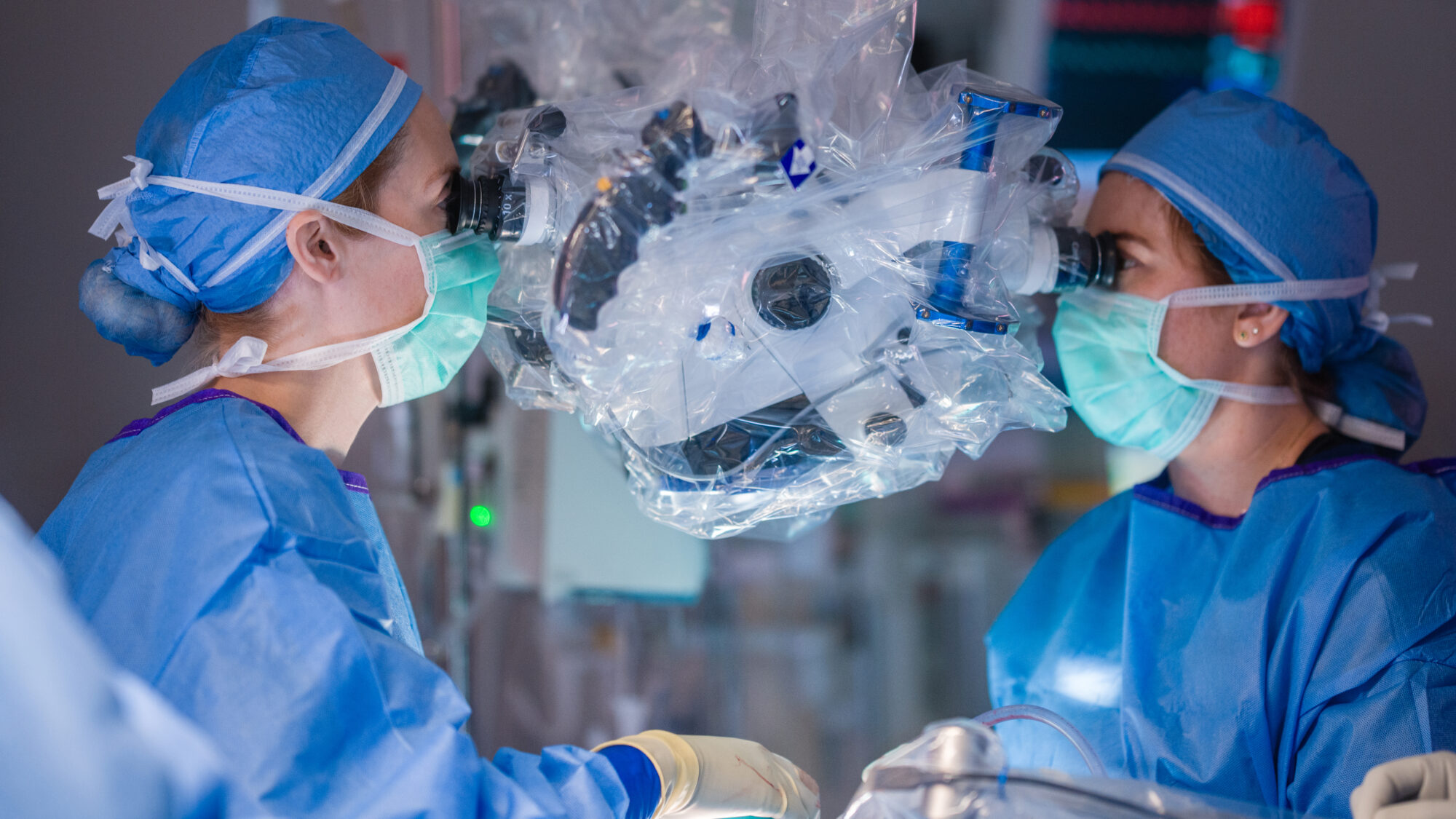 Photo of Dr. Snyder and a female neurosurgery resident performing surgery in the operating room at Barrow.
