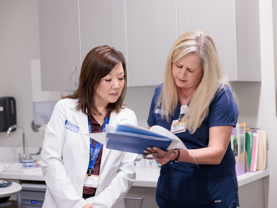 Dr. Lee-Ianotti looks over a chart with a nurse