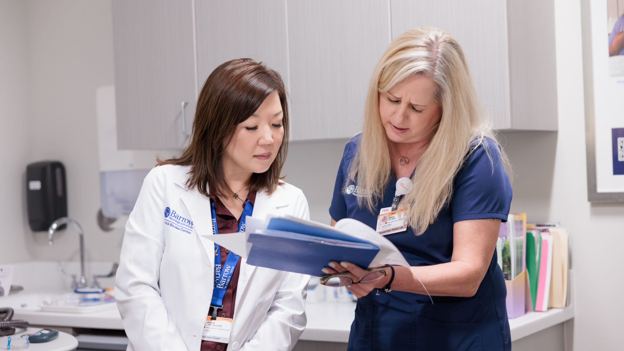 Dr. Lee-Ianotti looks over a chart with a nurse