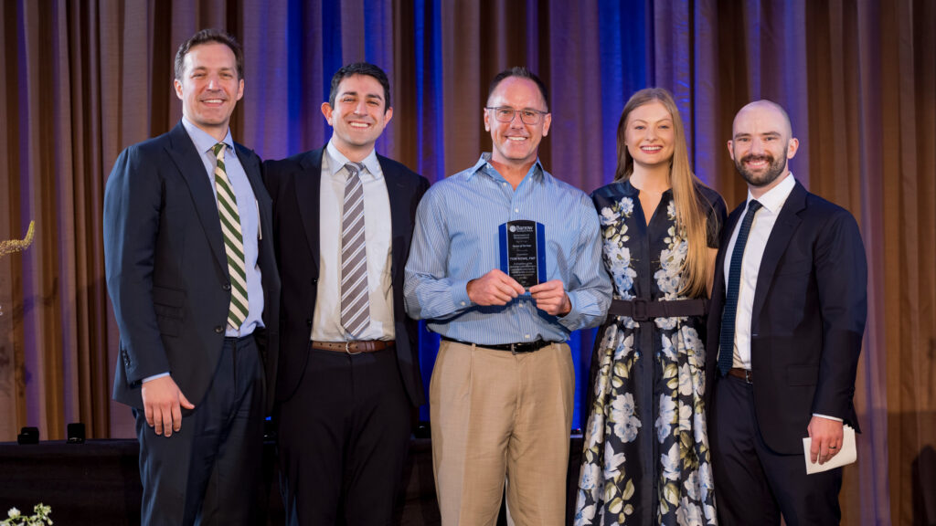 Tom Rowe is presented with the Nurse of the Year Award from the graduating neurosurgery residents in 2026