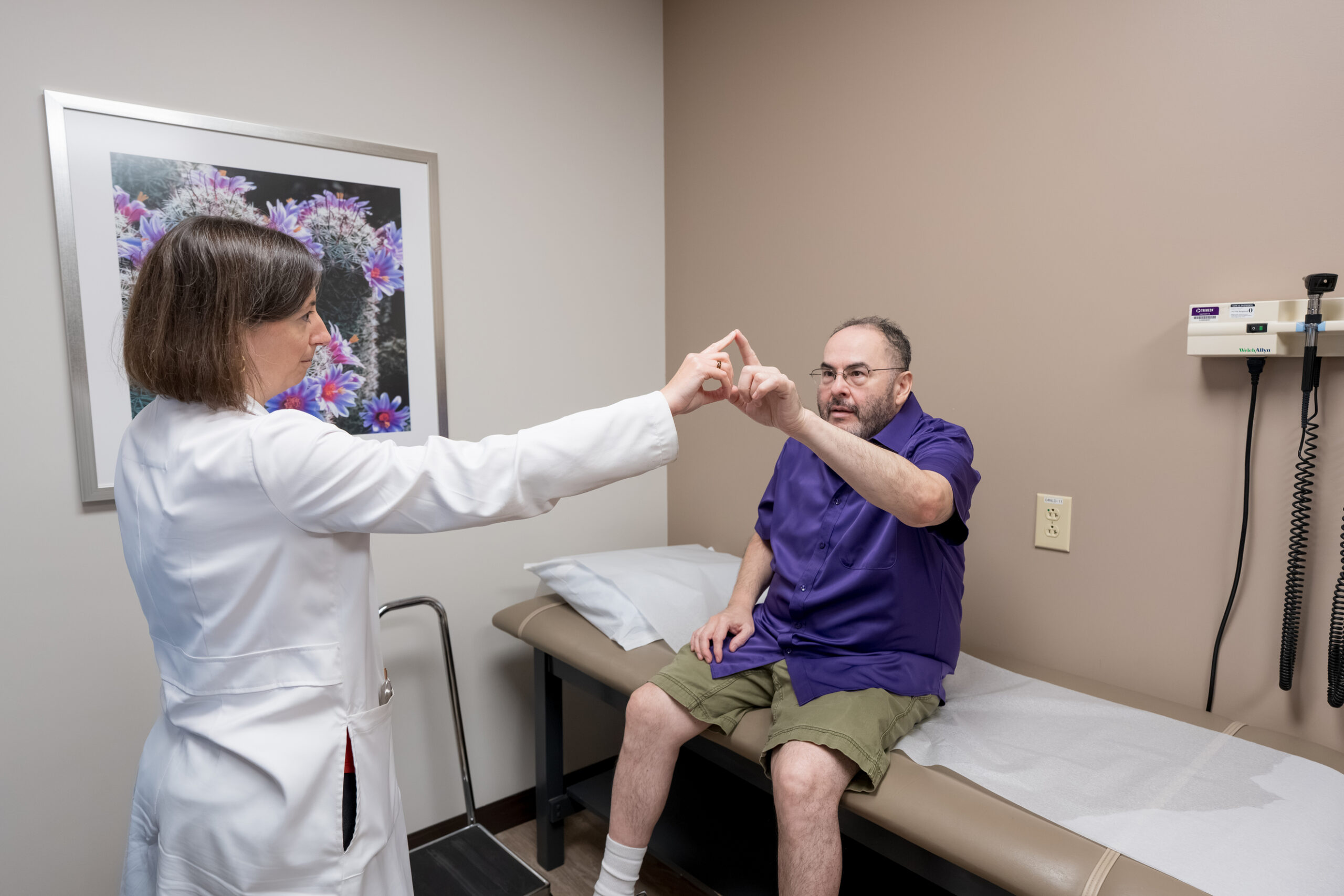 Dr. Deana Gazzola performs a neurological exam on patient George Zapien in the Barrow Epilepsy Center