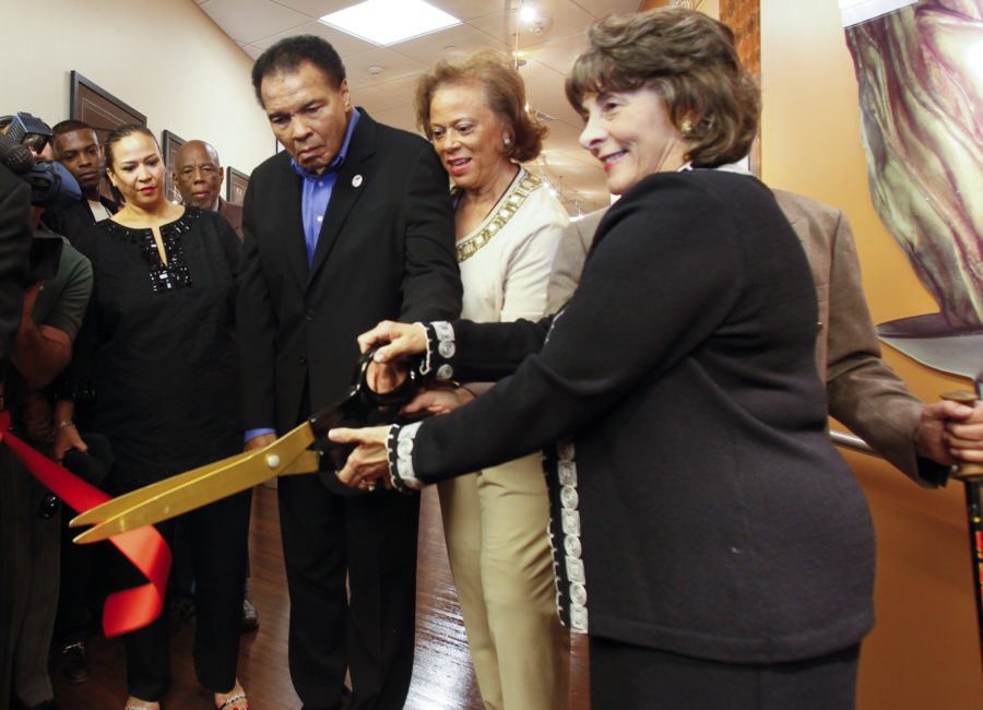 A photo of Muhammad Ali cutting the ribbon at the Muhammad Ali Parkinson Center