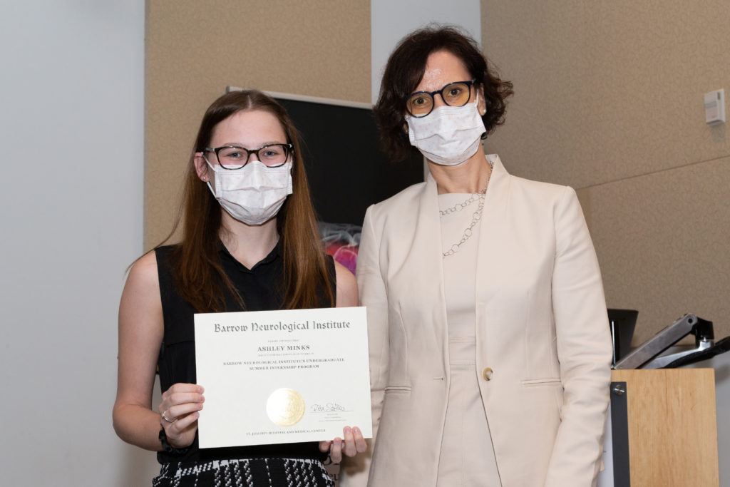 Ashley Minks holding a completion certificate and standing next to Dr. Rita Sattler