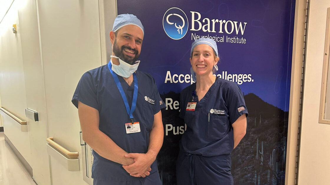 Dr. Amir Zolal and Dr. Laura Snyder pose for a photo outside of the operating room at Barrow.