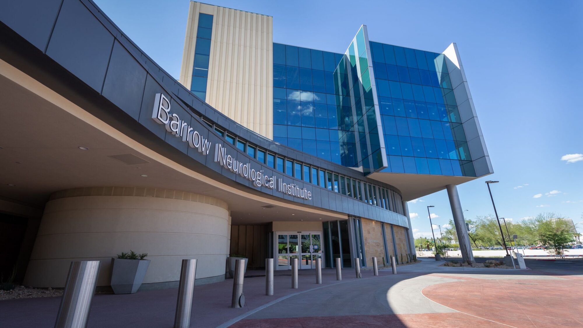 The main entrance to the Barrow Neuroplex in the daytime taken from the sidewalk level.