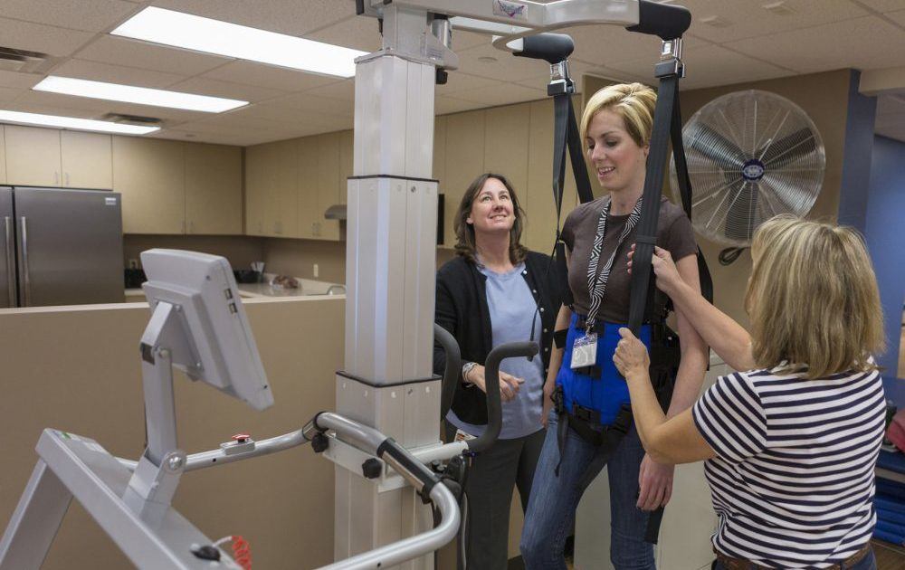 Woman using neuro-rehab device