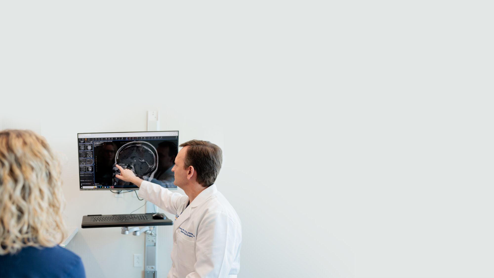pituitary neurosurgeon andrew little discusses an mri scan with a patient