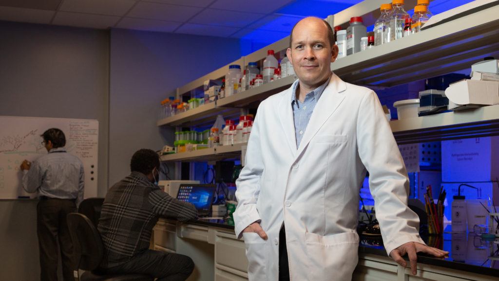 Dr. Chad Quarles poses in a laboratory