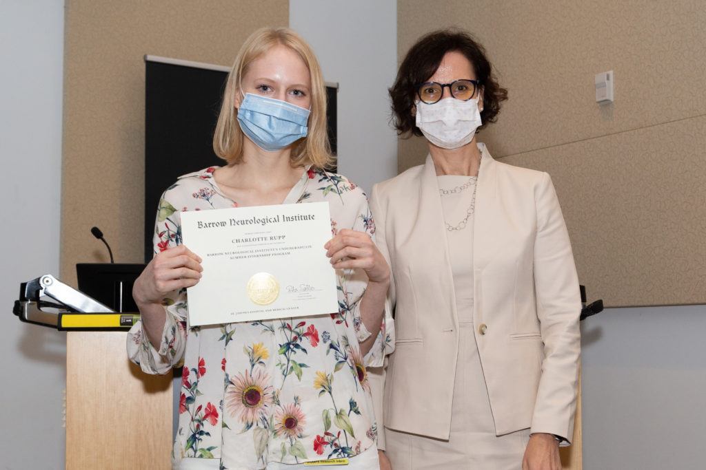 Charlotte Rupp holding a completion certificate and standing next to Dr. Rita Sattler