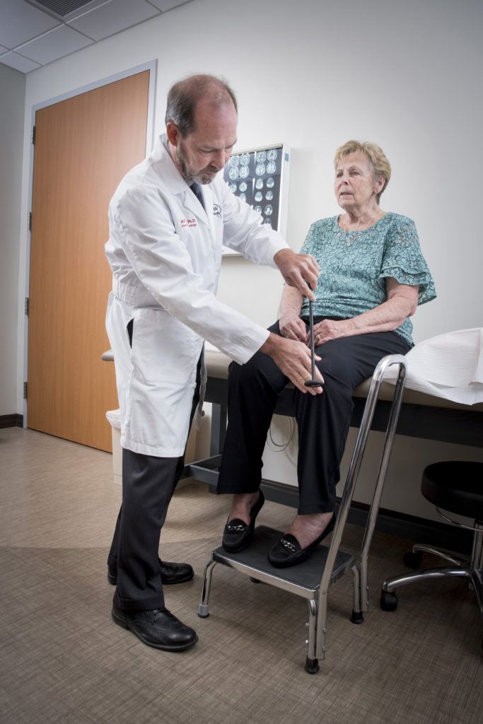 barrow neurologist michael waters examines a patient