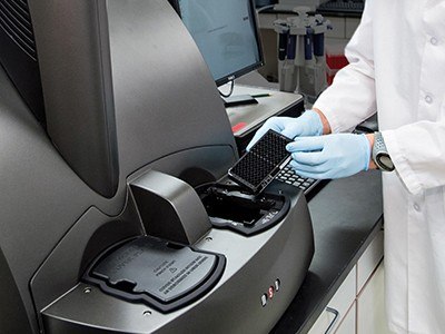 Healthcare professional using a flow cytometer in the ALS Lab at Barrow