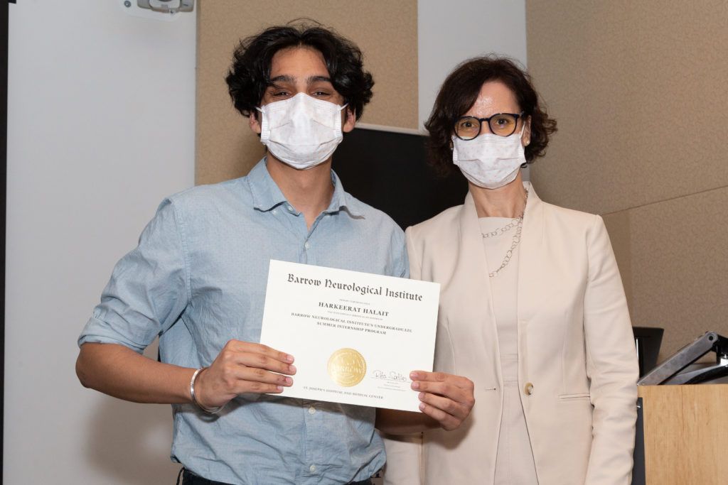 Picture of Harkeerat Halait holding a completion certificate and standing next to Dr. Rita Sattler