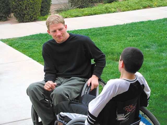 Paralympic Medalist having a discussion with a kid