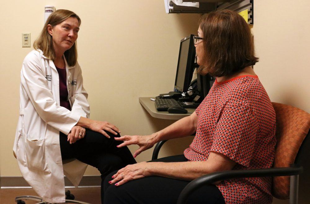 Parkinson's disease specialist Holly Shill speaks with a patient