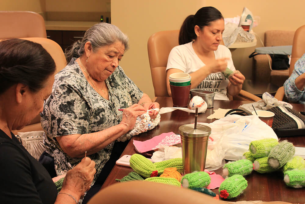 Hispanics with Parkinson's and their caregivers participate in a craft workshop at the Muhammad Ali Parkinson Center at Barrow