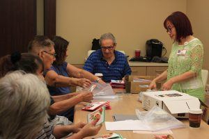 Patients and caregivers create holiday cards at the Muhammad Ali Parkinson Center