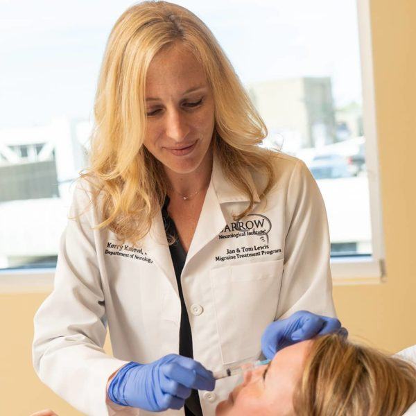 migraine specialist administers headache treatment