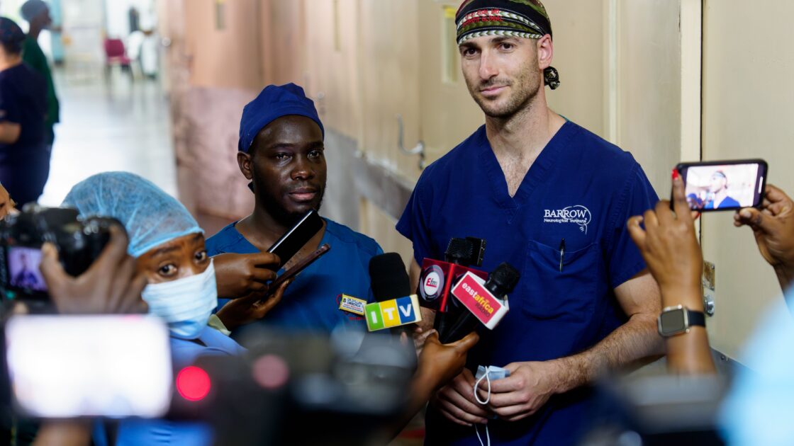 Barrow neurosurgery resident Cyrus Elahi, MD, is interviewed by media in Tanzania