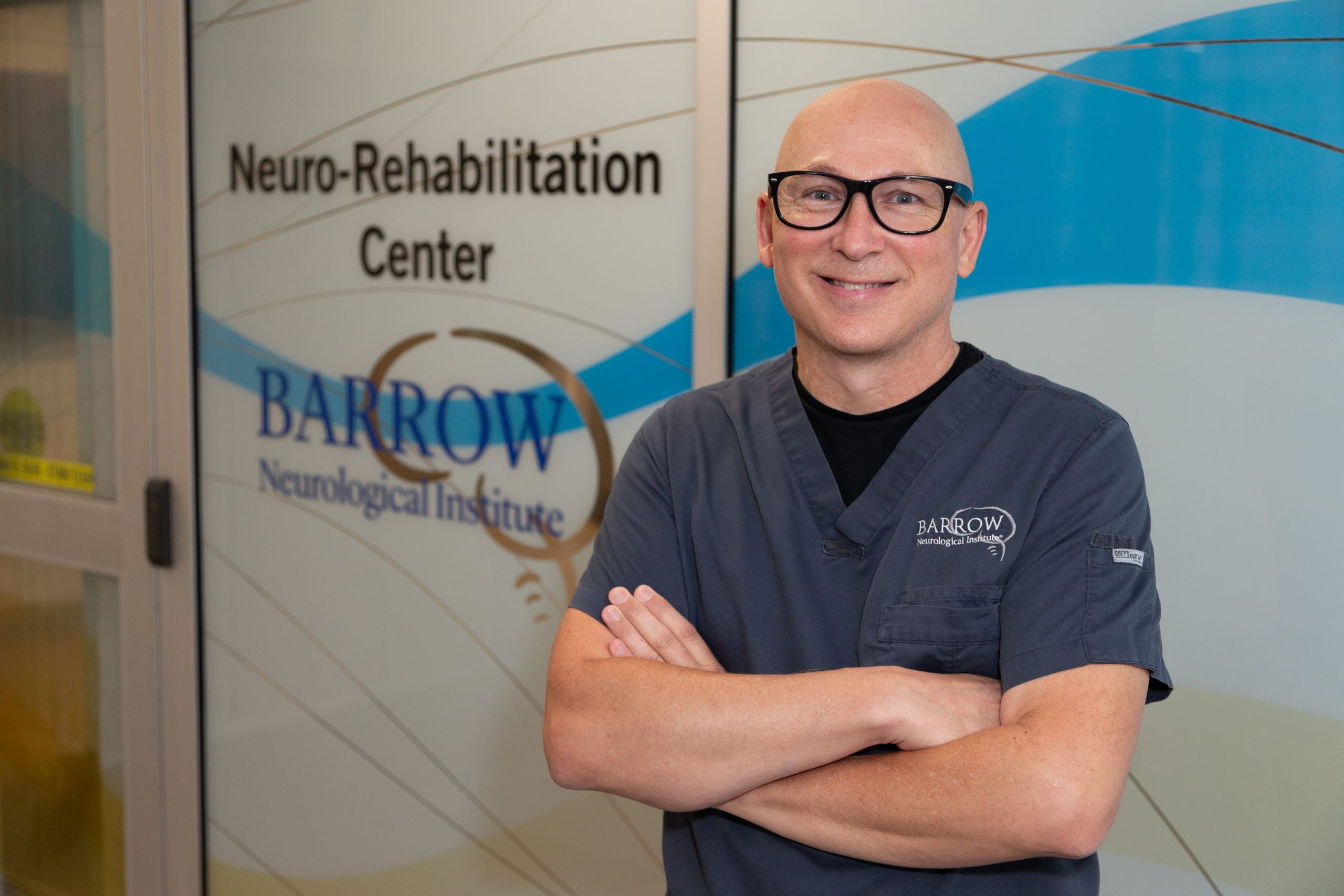 Kevin Patterson poses in front of the doors to the Barrow Neuro-Rehabilitation Center