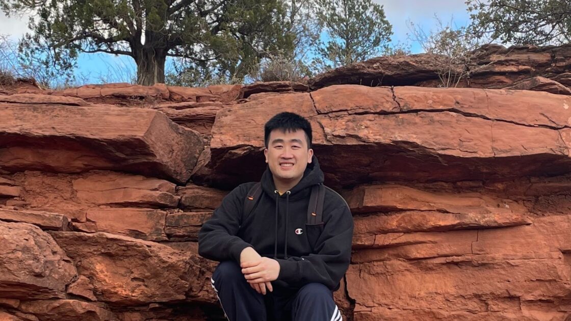 kevin dang in front of trees and red rocks