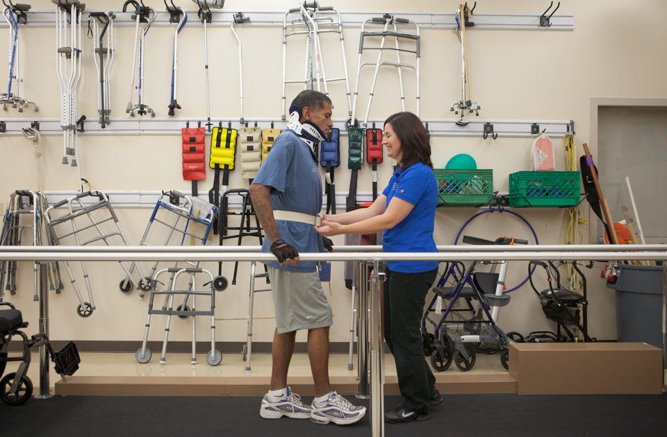 Neuro-rehab therapist works with patient