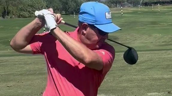 Photo of Nicholas Aretakis swinging a golf club