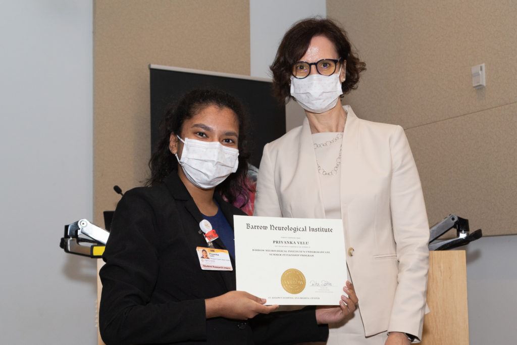 Priyanka Velu holding a completion certificate and standing next to Dr. Rita Sattler