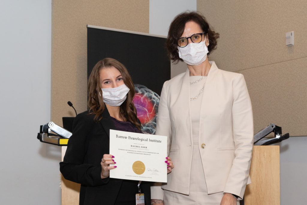 Rachel Eder holding a completion certificate and standing next to Dr. Rita Sattler