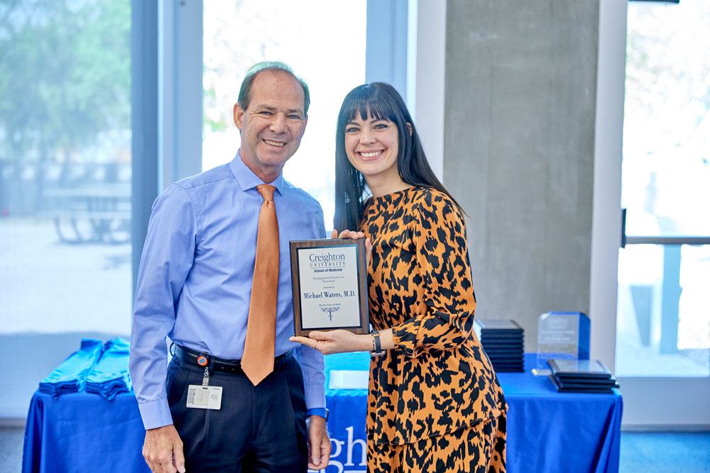 Dr. Michael Waters and Dr. Nicole Piedmonte pose with award