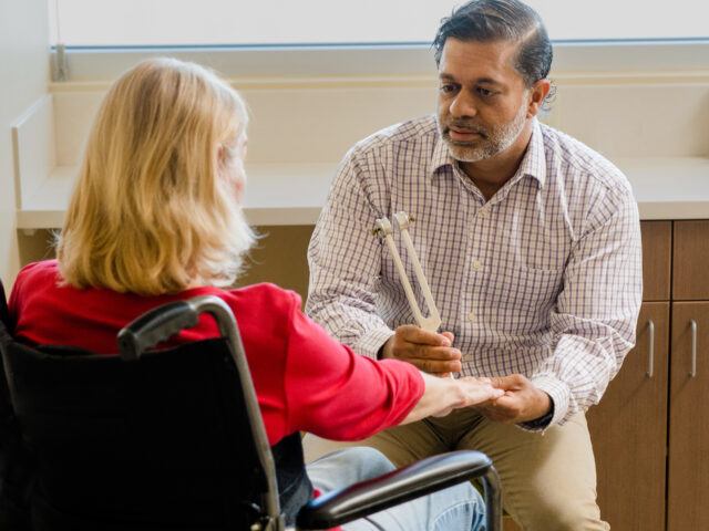 barrow neurologist doctor shafeeq ladha examines a patient with amyotrophic lateral sclerosis