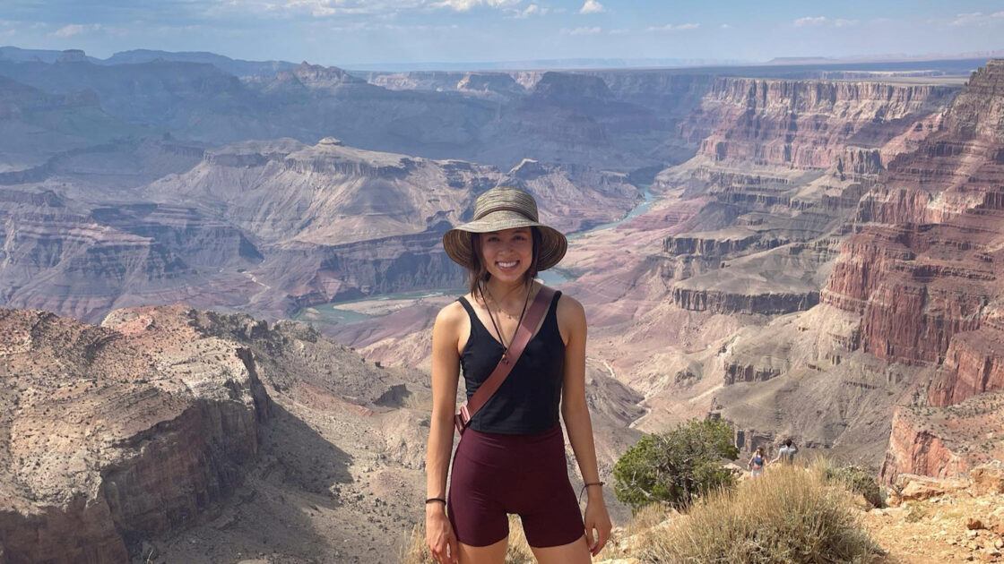 megan thomas standing in front of the grand canyon