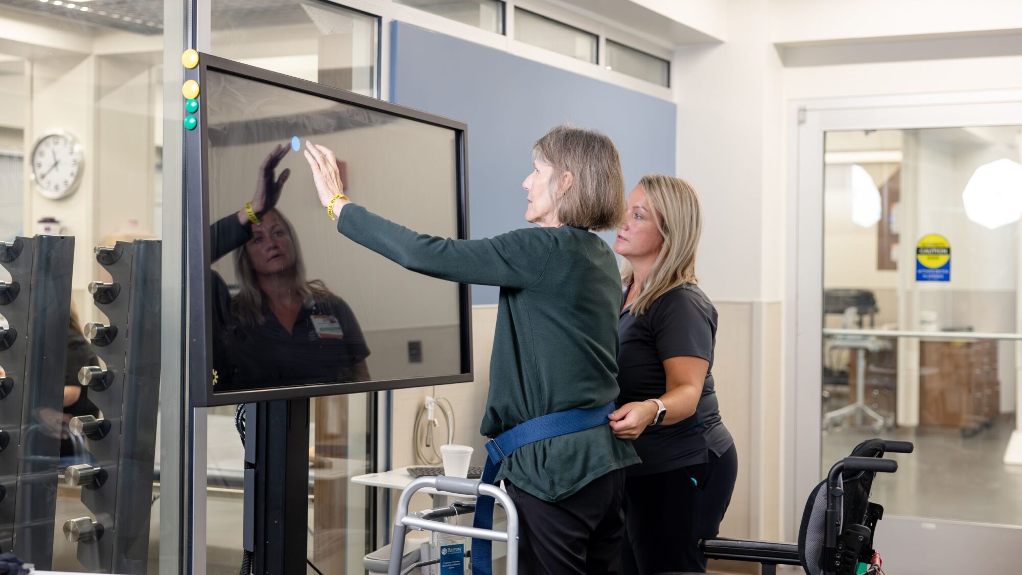 A physical therapist assists a patient using the bioness BITS system in the Barrow Neuro-Rehabilitation Center.