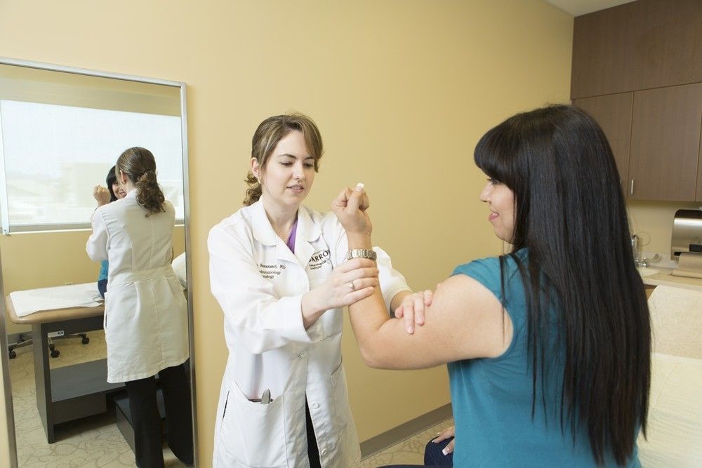 Photograph of multiple sclerosis specialist Aimee Borazanci examining a patient at barrow neurological institute in Phoenix, Arizona